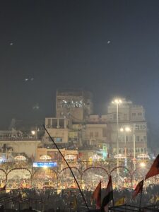 Priests performing Ganga Aarti at Dashashwamedh Ghat with illuminated lamps and chanting hymns.